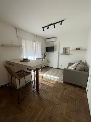 a living room with a table and a couch at Chile 210, Nueva Cordoba in Cordoba