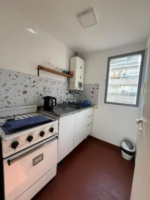 a small kitchen with a stove and a sink at Chile 210, Nueva Cordoba in Cordoba