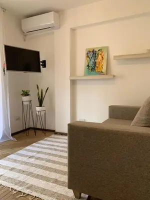 a living room with a couch and a flat screen tv at Chile 210, Nueva Cordoba in Cordoba
