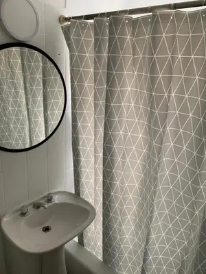 a bathroom with a shower curtain and a sink at Chile 210, Nueva Cordoba in Cordoba
