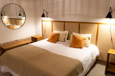a bedroom with a large bed with orange pillows at Gardenia Select in San Javier