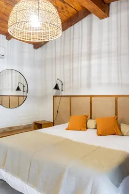 a bedroom with a large bed with orange pillows at Gardenia Select in San Javier
