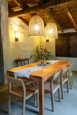 a dining room table with chairs and two chandeliers at Gardenia Select in San Javier