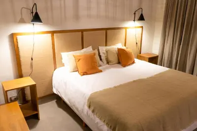 a bedroom with a large bed with two lamps at Gardenia Select in San Javier