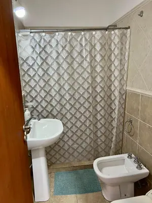 a bathroom with a toilet and a sink and a shower at Depto 8 - Villa Carlos Paz in Villa Carlos Paz