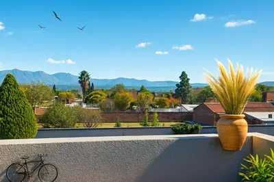 a bike sitting on a balcony with a view of a city at El canto de los pajaros in Villa Carlos Paz
