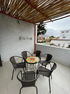a patio with a table and chairs on a balcony at El canto de los pajaros in Villa Carlos Paz