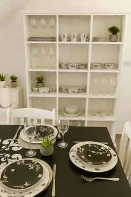 a dining room table with plates and wine glasses at El canto de los pajaros in Villa Carlos Paz