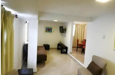 a living room with a couch and a table at Departamento zona centrica en Villa Carlos Paz in Villa Carlos Paz