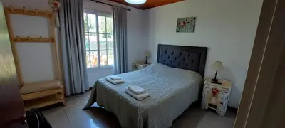 a bedroom with a bed with two towels on it at Cabaña VGB. in Villa General Belgrano