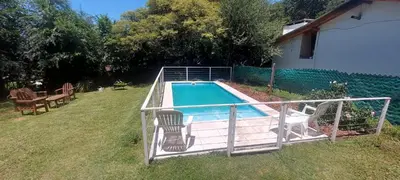 a swimming pool in the backyard of a house at Cabaña VGB. in Villa General Belgrano