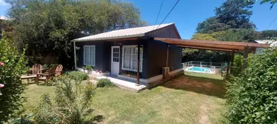 a tiny house with a pool in a yard at Cabaña VGB. in Villa General Belgrano