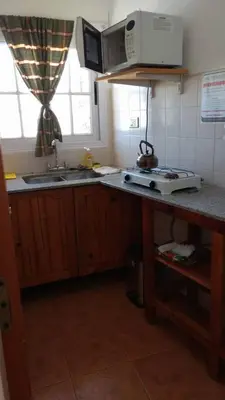 a kitchen with a sink and a microwave at Departamento Centro Calamuchita in Santa Rosa de Calamuchita