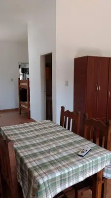 a kitchen with a table with a plaid table cloth on it at Departamento Centro Calamuchita in Santa Rosa de Calamuchita