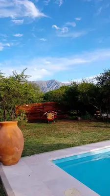 a large vase sitting next to a swimming pool at Valle de Fatima in Villa de Las Rosas