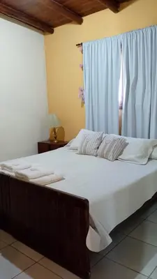 a large bed in a room with a window at Valle de Fatima in Villa de Las Rosas