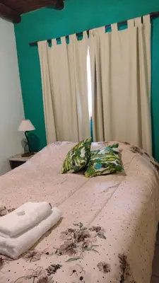 a bedroom with a bed with two pillows on it at Valle de Fatima in Villa de Las Rosas
