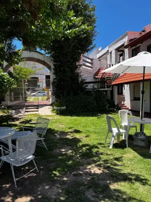 a group of chairs and a table and an umbrella at Sauce Viejo in Mina Clavero