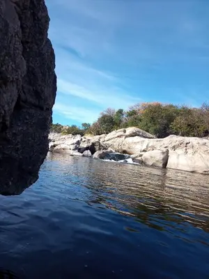 a view of a river with rocks and water at Sauce Viejo in Mina Clavero