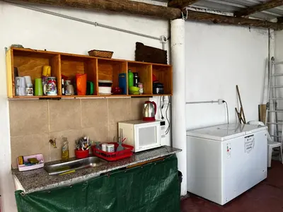 a kitchen with a counter with a microwave and a refrigerator at Sauce Viejo in Mina Clavero