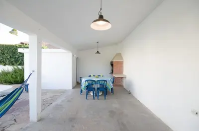 a dining room with a table and chairs at Casa en Villa Carlos Paz con Pileta , Quincho y Jardín a Pasos del Centro in Villa Carlos Paz