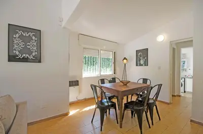 a dining room with a table and chairs at Casa en Villa Carlos Paz con Pileta , Quincho y Jardín a Pasos del Centro in Villa Carlos Paz