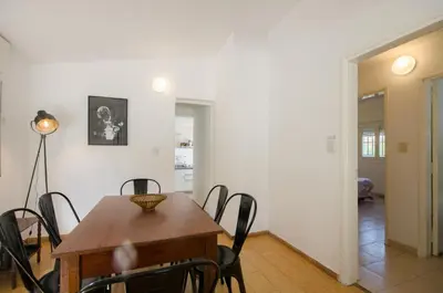a dining room with a table and chairs at Casa en Villa Carlos Paz con Pileta , Quincho y Jardín a Pasos del Centro in Villa Carlos Paz
