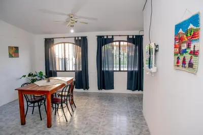 a dining room with a table and chairs at Alojamientos Bolivar in Mina Clavero