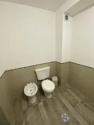 a bathroom with a toilet and a bidet at La Herradura Village in Merlo
