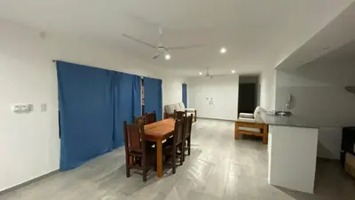 a dining room with a table and a blue wall at La Herradura Village in Merlo