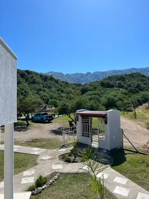 a small building with a view of a mountain at La Herradura Village in Merlo
