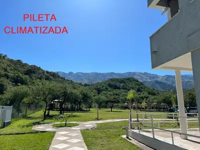 a view of a park with mountains in the background at La Herradura Village in Merlo