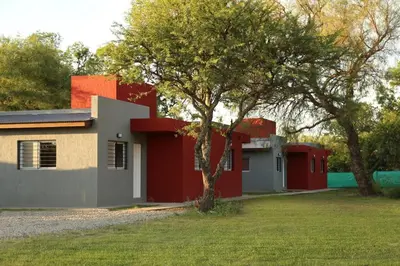 a house with a tree in front of it at Casitas Despertar del Valle in Merlo