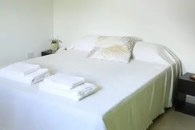 a white bed with towels on top of it at Casitas Despertar del Valle in Merlo