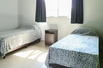 a bedroom with two twin beds and a window at Casitas Despertar del Valle in Merlo