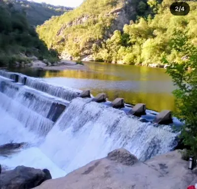 a waterfall in the middle of a river at Cabaña Los Algarrobos in Villa Icho Cruz