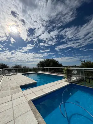a swimming pool on the roof of a house at Algarrobo Nieto in Merlo