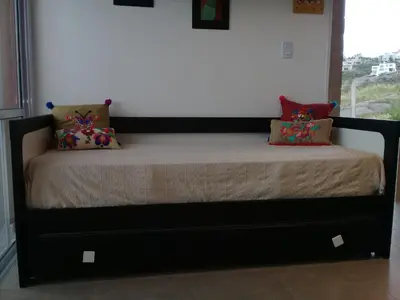 a bed with two pillows on it in a room at Dúplex La Delfina 2 in Villa Carlos Paz