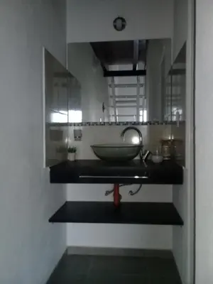 a bathroom with a sink with a bowl on the counter at Dúplex La Delfina 2 in Villa Carlos Paz