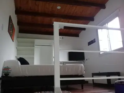 a living room with a couch and a window at Dúplex La Delfina 2 in Villa Carlos Paz