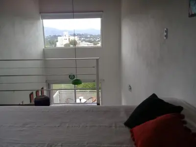 a bedroom with a bed and a large window at Dúplex La Delfina 2 in Villa Carlos Paz