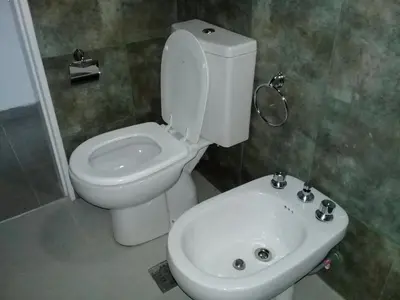 a bathroom with a toilet and a sink at Dúplex La Delfina 2 in Villa Carlos Paz
