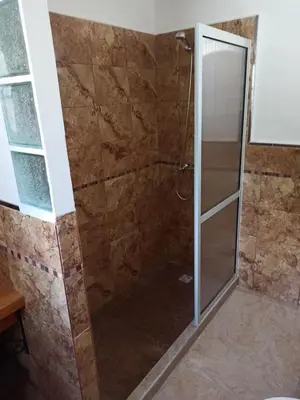 a shower with a glass door in a bathroom at Cabaña El Canal II in Villa Carlos Paz