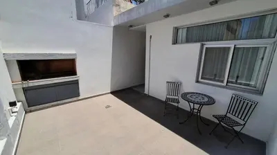 a room with two chairs and a table and some windows at LitStay Caseros con cochera in Cordoba