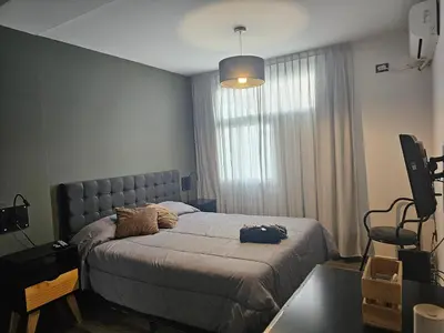 a bedroom with a bed and a television in it at LitStay Caseros con cochera in Cordoba