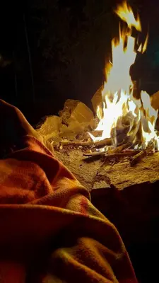a fire pit with a person sitting in front of it at Cabaña Balcón Serrano in Cortaderas