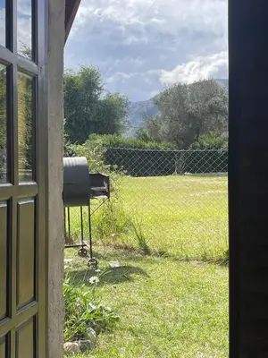 a view from a window of a yard with a fence at Cabaña Balcón Serrano in Cortaderas