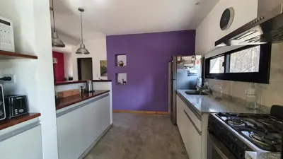 a kitchen with a purple wall and a refrigerator at ASM CASA I in Merlo