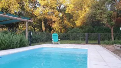 a blue chair sitting next to a swimming pool at ASM CASA I in Merlo