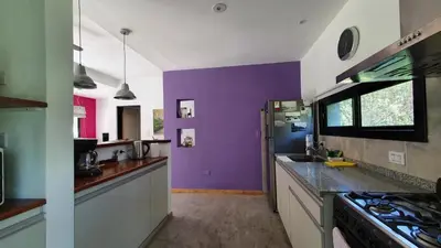 a kitchen with purple and white walls and a stove at ASM CASA I in Merlo